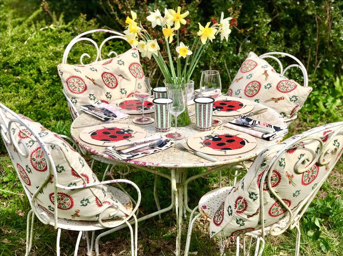 Table Outdoors with four chairs and cushions